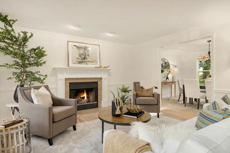 Retire to the living room from the adjacent dining room. Brand new wide plank oak floors!