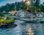An idyllic waterfront lifestyle and setting with panoramic 240+ degree views, a sandy beach area, and a boat ramp!