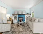 Living Room with timeless charm and original fireplace with gas insert.