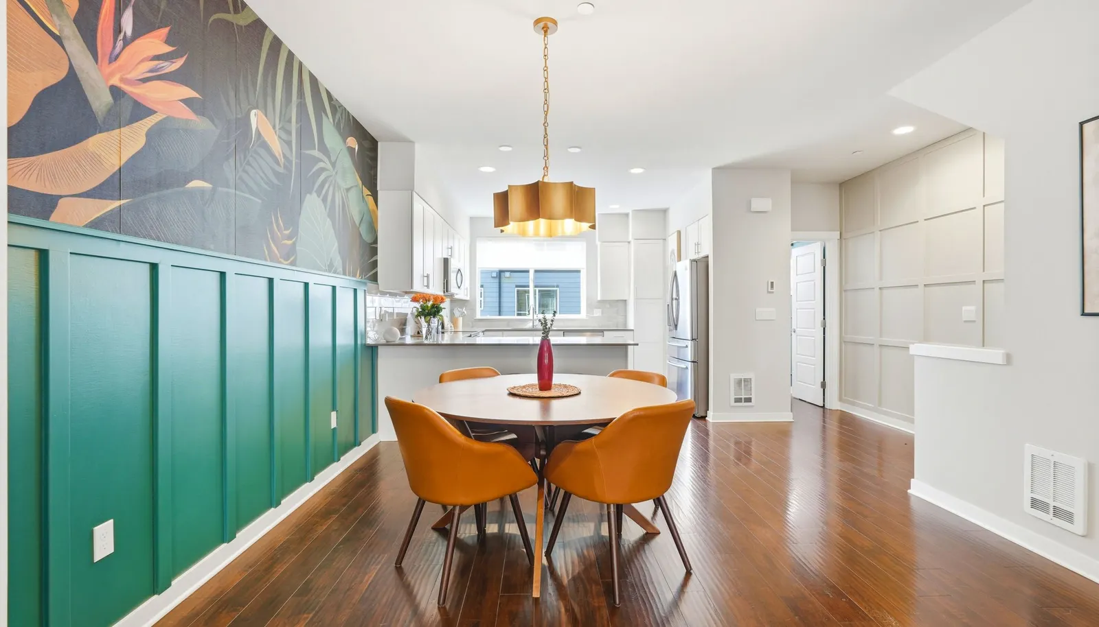 The dining area features an upgraded light fixture and a striking wallpaper, an eye-catching focal point full of personality.