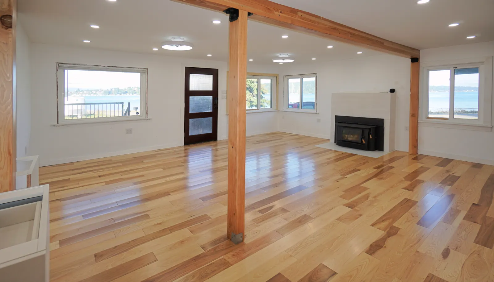 Main level living room and main entrance. Wood burning fireplace. Spectacular waterfront views!