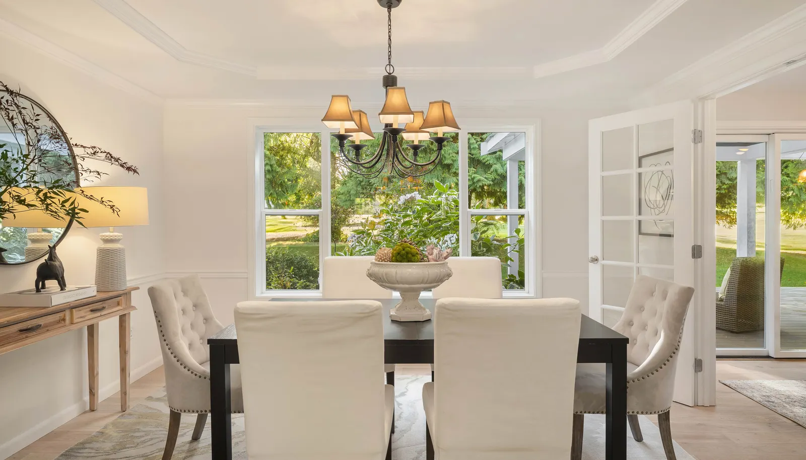 Dining room with view window to the backyard and gardens. Note the coffered ceiling and French doors!