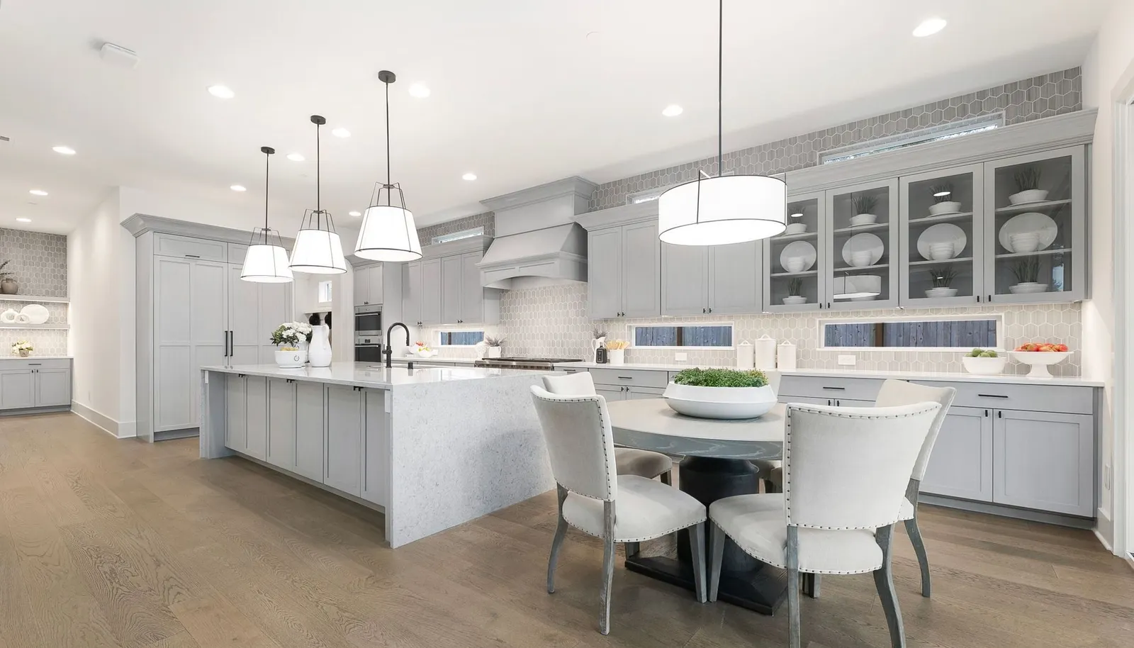 Large Entertaining Island w/ Waterfall Edge and Decorative Pendant Lighting.