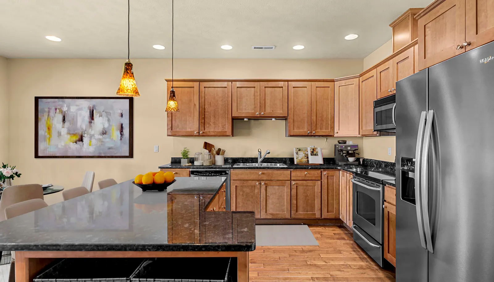 Gourmet kitchen with warm wood cabinetry, full appliance suite, and ample counter space