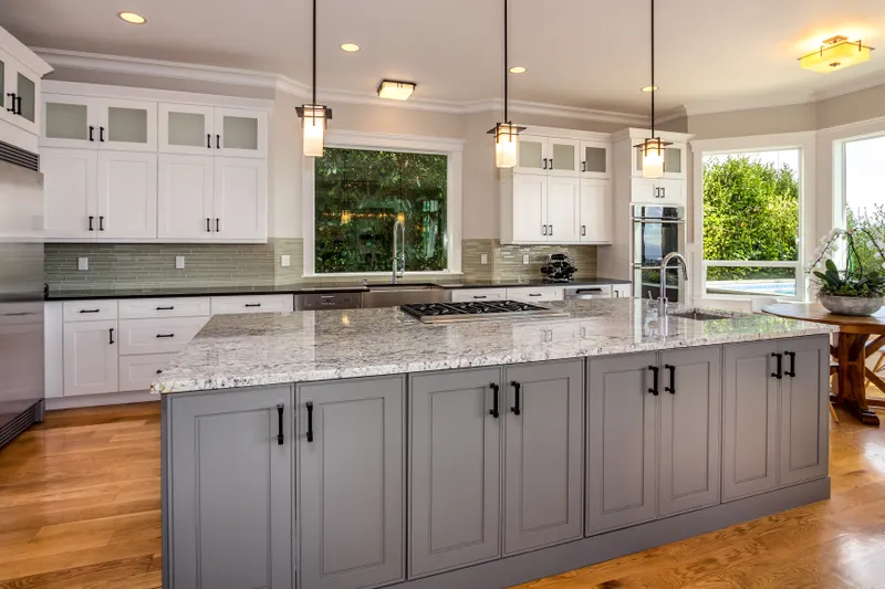 Flowing open floor plan where the cook can look at the view from command central -- the propane six burner Wolf cooktop.