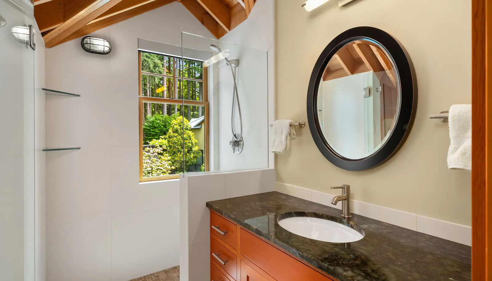 The en-suite bath of the upper east bedroom with large shower overlooking the gardens