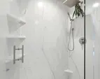 The shower has been recently remodeled with a low-maintenance, grout-free floor and surround for effortless upkeep.