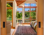 The primary suite is tucked away for privacy while still being integrated with the outdoor spaces. 