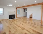 Living room with wood stove and spectacular views. doorway leads to the stairway up and the to the back entry near the driveway.