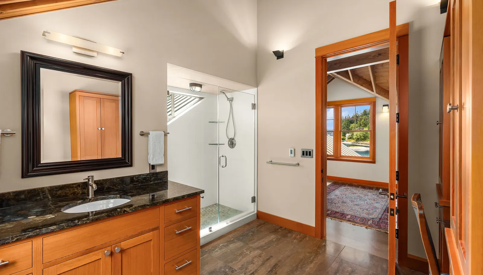 The en-suite bath of the upper west bedroom with a large shower and vanity