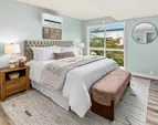 Spacious primary bedroom featuring scenic views and a private ensuite bathroom.