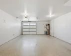Extra-deep 2-car tandem garage upgraded with epoxy flooring, insulation and finished walls.