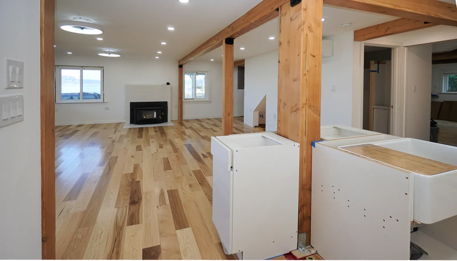 The dishwasher will be installed next to the plantation sink. Quartz countertops to cover every part of the island all the way around the center post. The first doorway to the right of center is the 3
