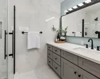 Primary en-suite bathroom featuring a spacious counter, a walk-in shower, and direct access from the primary bedroom.