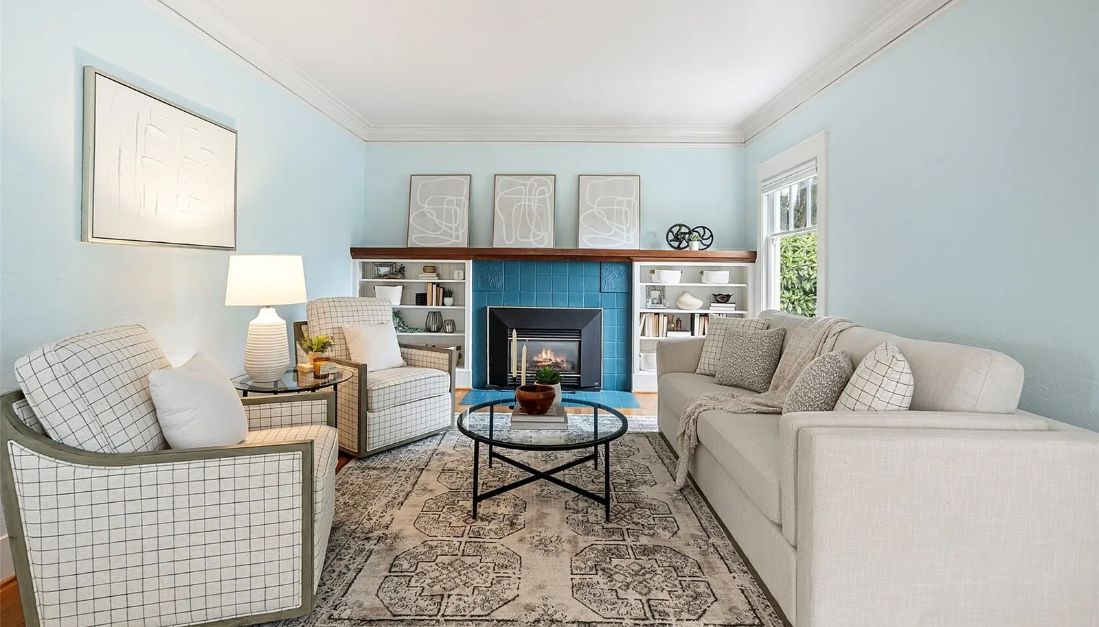 Living Room with timeless charm and original fireplace with gas insert.