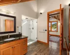 The en-suite bath of the upper west bedroom with a large shower and vanity