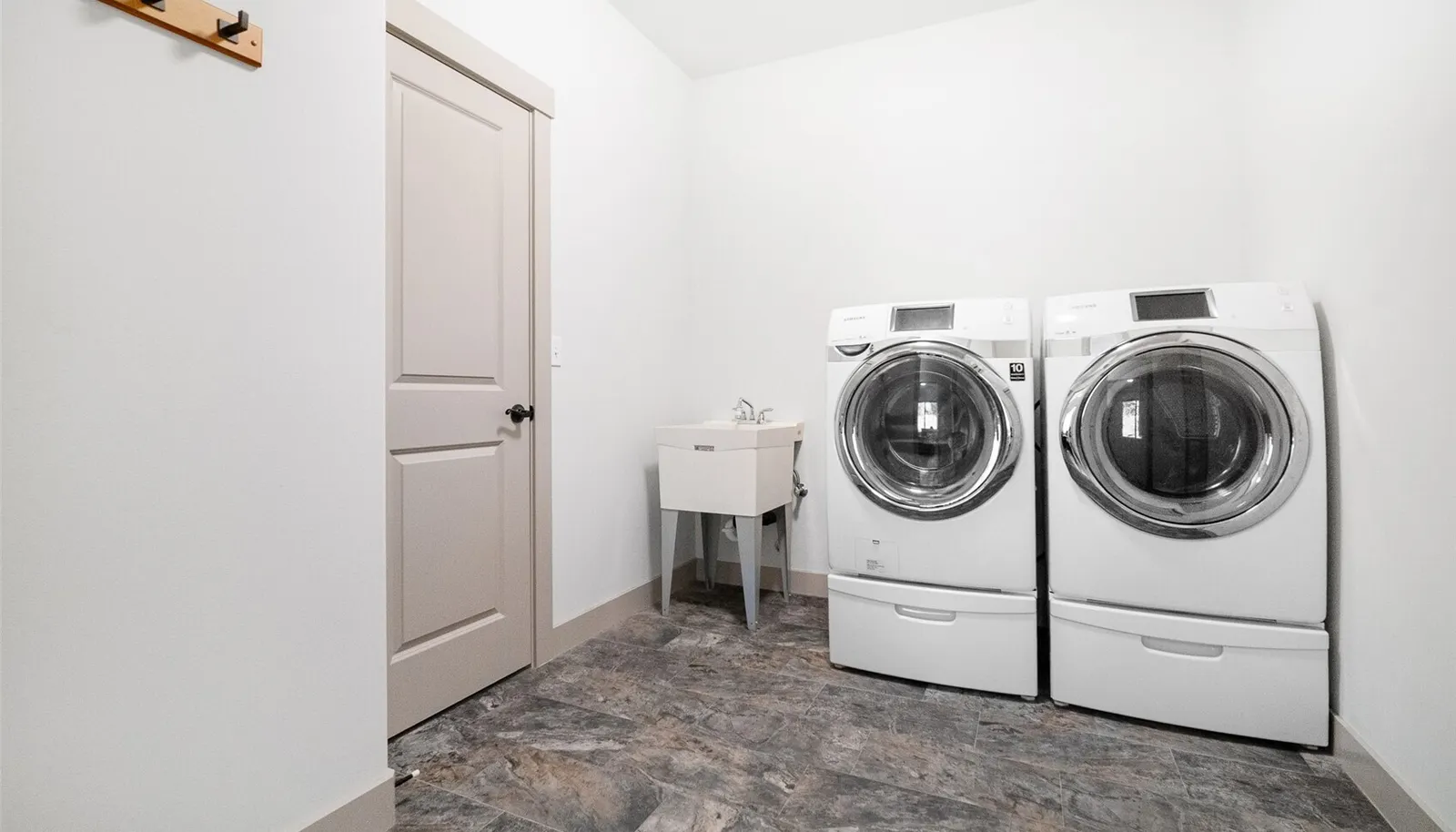 Laundry space with garage access, functioning as a mud room with storage closet.