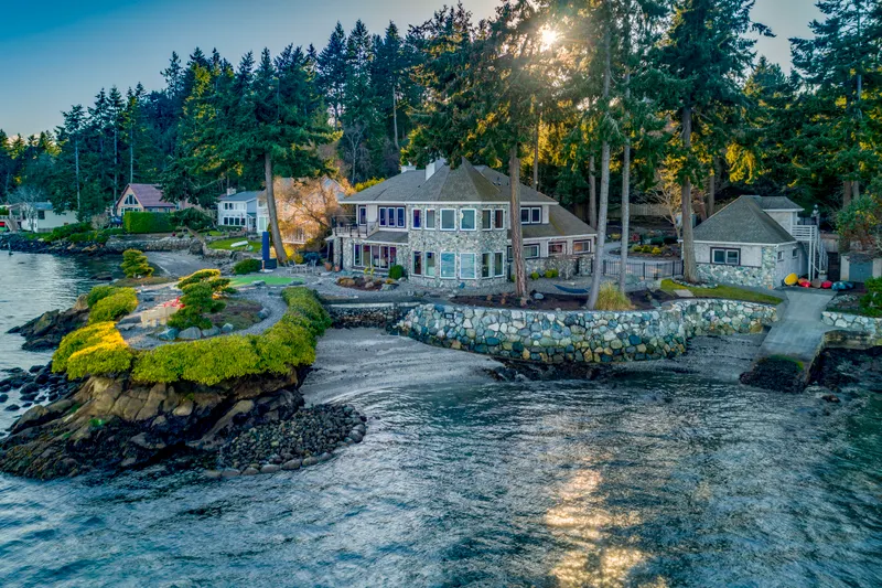An idyllic waterfront lifestyle and setting with panoramic 240+ degree views, a sandy beach area, and a boat ramp!