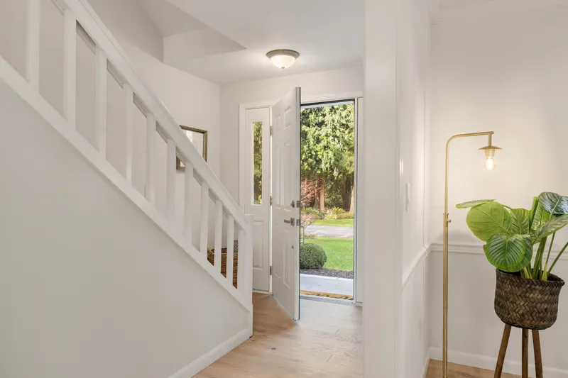 View from the living room to the front door. New designer paint throughout the entire home!