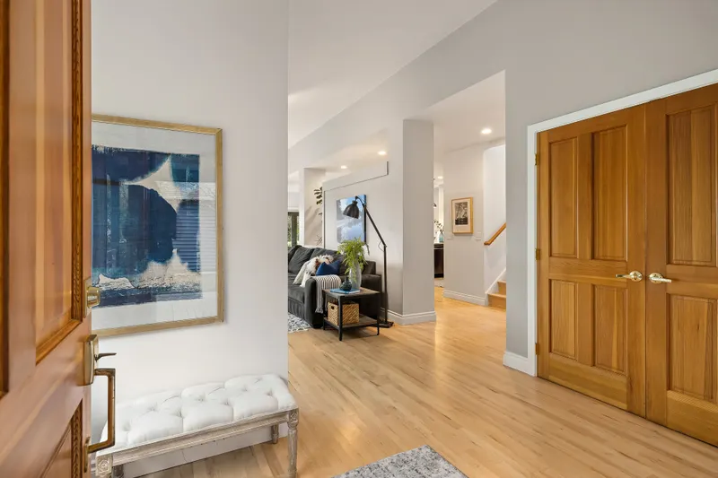 Spacious front entry showcases the beautiful maple floors and open floor plan