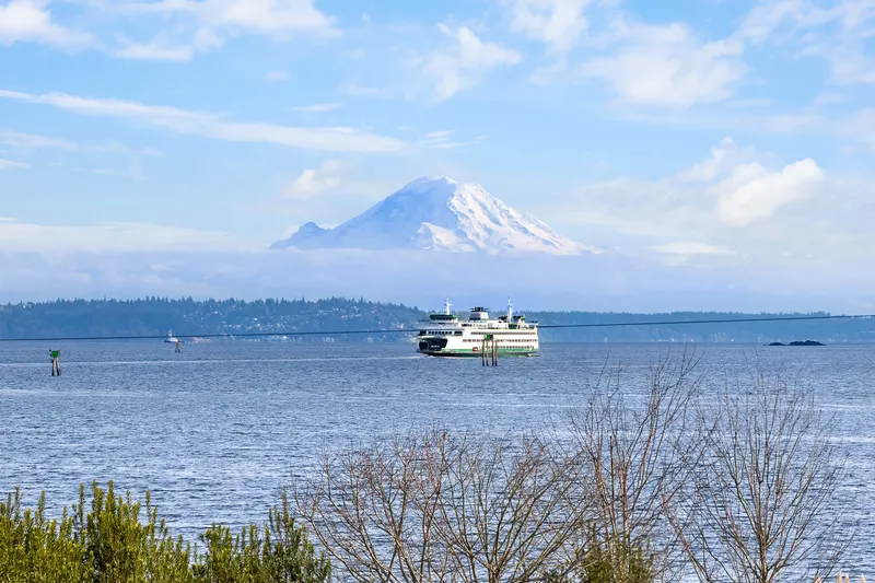 Breathtaking views of Mt. Rainier straight away with deep blue Puget Sound and passing ferries in the foreground.