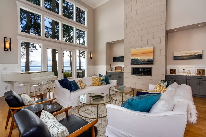 Grand living room, soaring windows and views as far as your eyes can see. Conversations stay cozy by the fireplace. Incredible.
