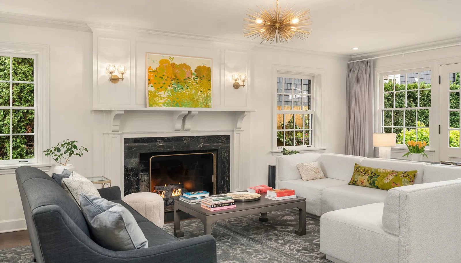 Windows on all sides flood this room with happy sunshine. There is a door on the back wall that leads out to the backyard & patio.