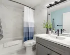 Bright and airy guest bathroom featuring modern fixtures.