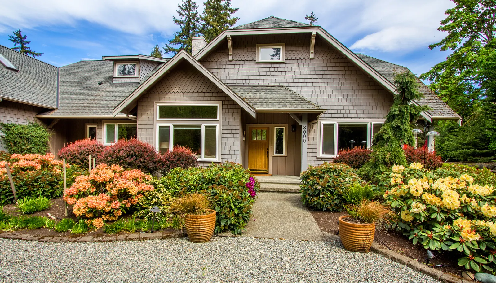 Professionally landscaped with color throughout every season, the entry way draws you in with rich vibrant plantings.