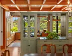 The buffet partition from the kitchen to the dining room with glass case storage and accordion doors that allow the kitchen to be closed off for dinners 