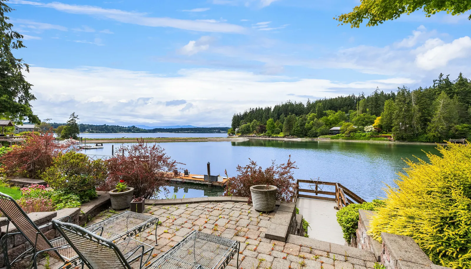 The beachfront patio is tucked in the tiered waterside gardens. Warm sun and privacy overlooking the changing tides