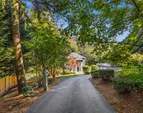 Set on a level and usable acre, the private driveway leads you to an expansive 4,360 sq. ft. home
