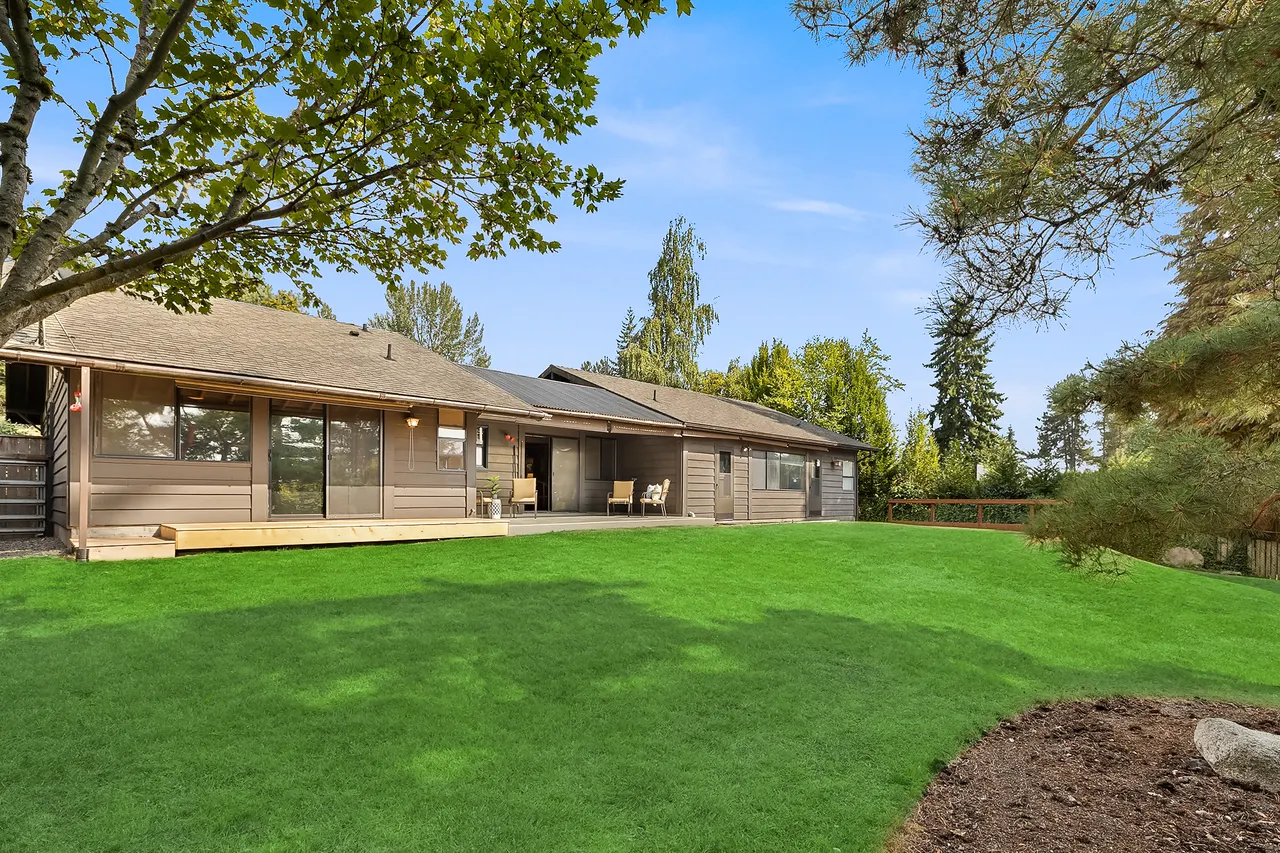 This is a view of the backyard showing a large lawn (it is now seasonally brown). The backyard is fenced. This is a view of the backyard showing a large lawn (it is now seasonally brown). The backyard is fenced.