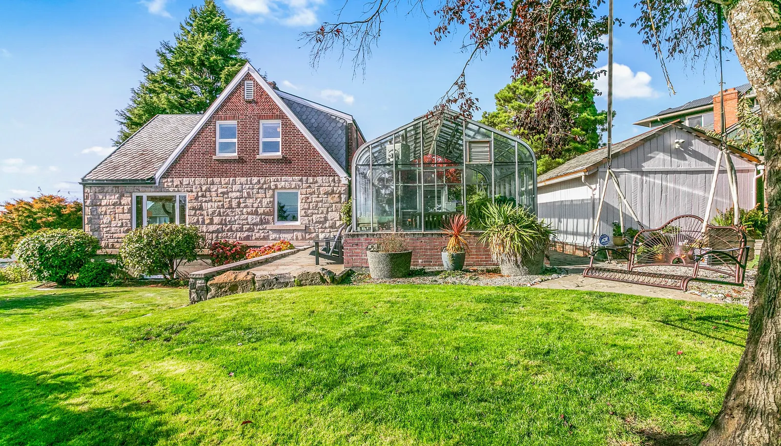 Side yard, greenhouse with stone patio, and storage shed. Side yard, greenhouse with stone patio, and storage shed.