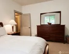 Primary bedroom on main floor, positioned for privacy, overlooking the back garden.