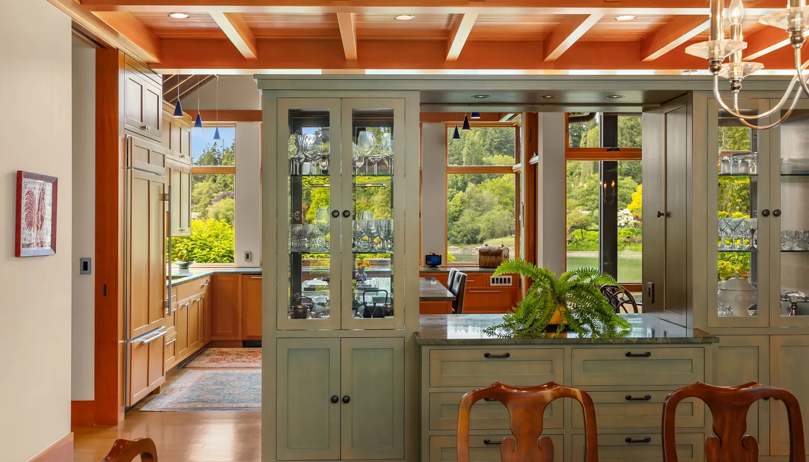 The buffet partition from the kitchen to the dining room with glass case storage and accordion doors that allow the kitchen to be closed off for dinners 