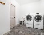 Laundry space with garage access, functioning as a mud room with storage closet.