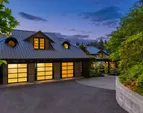The three car garage includes extra storage, separate entry to the studio and doors that open to the upper gardens. 