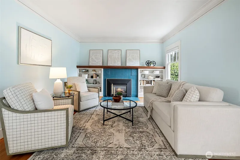 Living Room with timeless charm and original fireplace with gas insert.