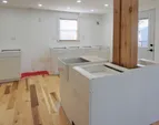 Kitchen island with plantation sink will have quartz countertops and a dishwasher on the far side. Base cabinets will have uppers along the wall, to be installed soon.
