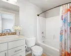 The well-appointed secondary bathroom provides comfort and privacy for guests or shared living.