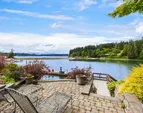The beachfront patio is tucked in the tiered waterside gardens. Warm sun and privacy overlooking the changing tides