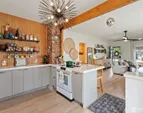 The kitchen has been extensively refreshed with new cabinetry, appliances, and distinctive concrete countertops