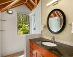 The en-suite bath of the upper east bedroom with large shower overlooking the gardens