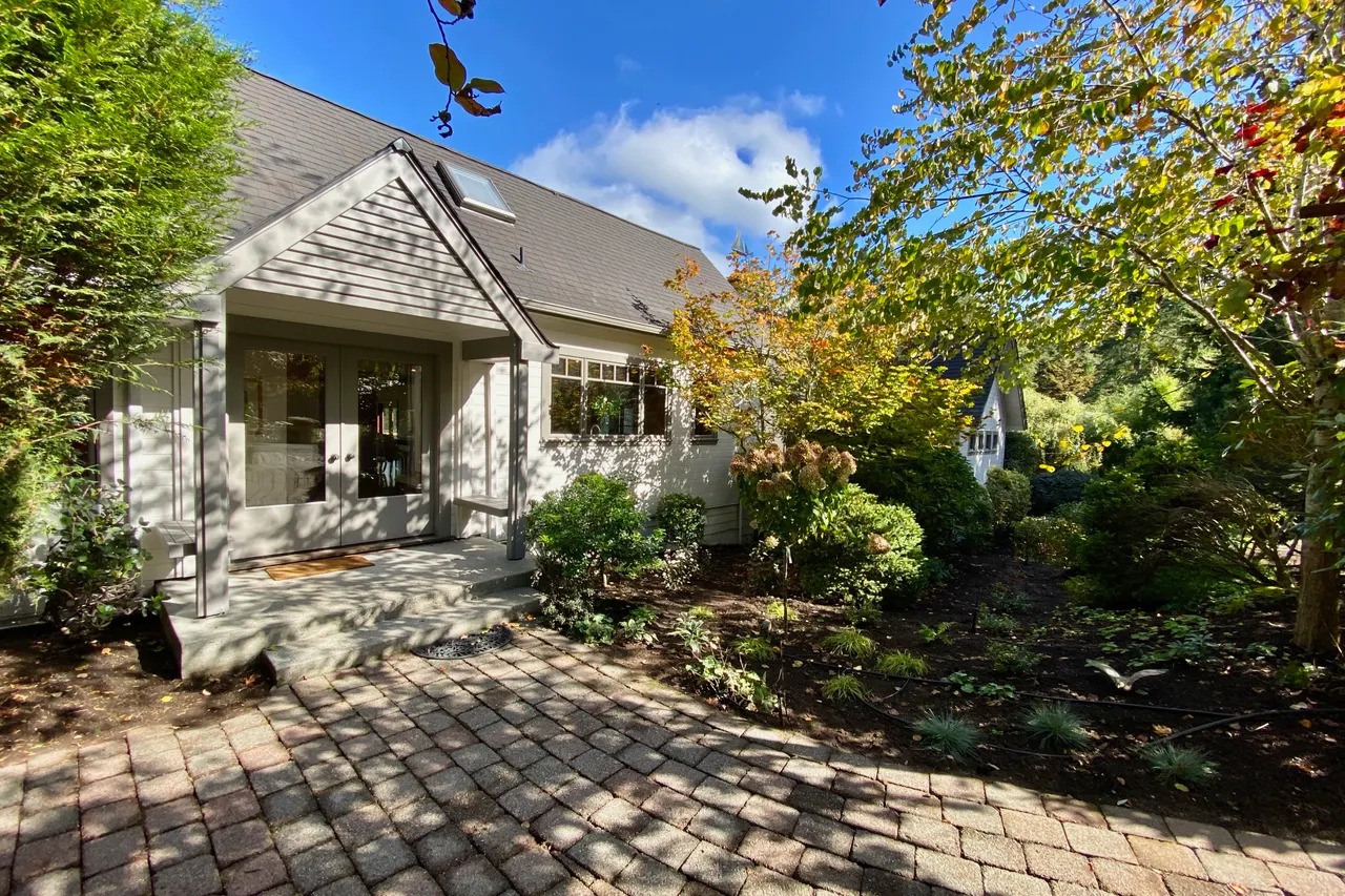 Paleo stones lead through the gardens to the original entrance of the home. New roof and all new exterior paint!