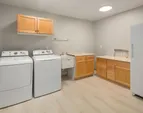 Large utility room has storage space for all your needs.