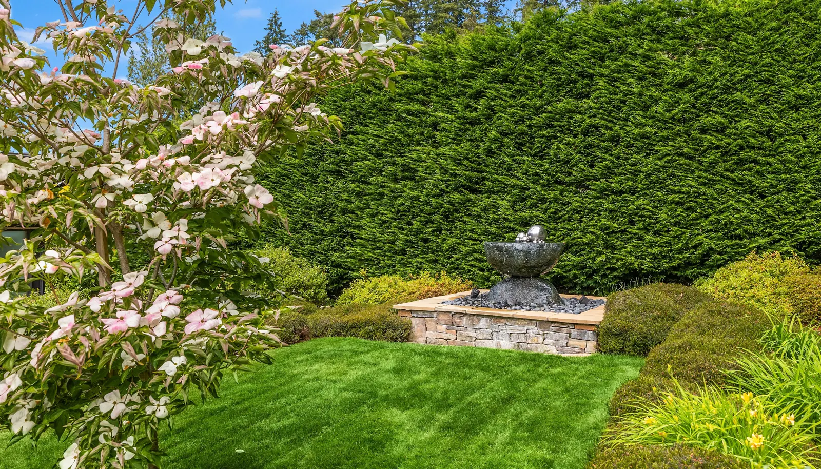 The artist designed garden fountain helps this space capture all the senses. 