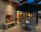 The outdoor wood-burning fireplace on the covered patio