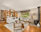 The living room has built-in shelves, a propane free-standing stove, bamboo floors, and is open to the dining area. The living room has built-in shelves, a propane free-standing stove, bamboo floors, and is open to the dining area.