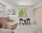 Additional view of bedroom overlooking tranquil garden.